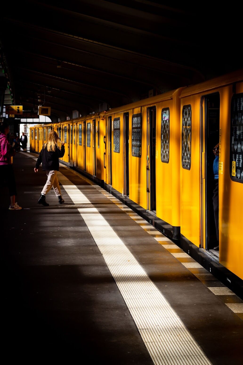 Yellow U-Bahn Train: The interior of a yellow U-Bahn train with doors open at a station.