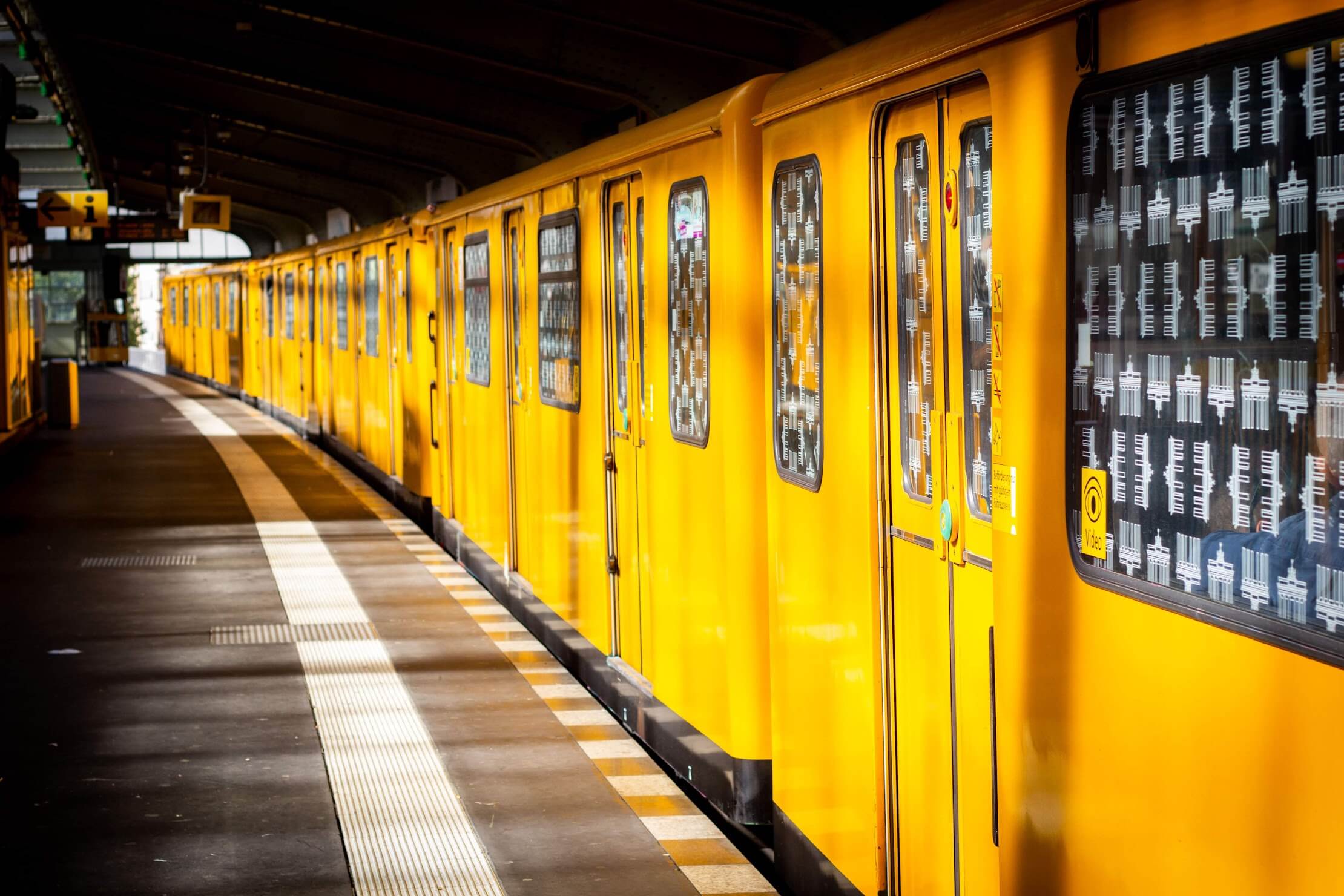 U-Bahn Train: A yellow U-Bahn train arriving at an underground station in Berlin.