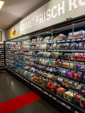 An aisle in a Berlin grocery store filled with a wide selection of plant-based products.