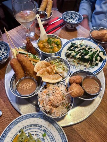 A platter of assorted vegan dishes, including fried items and salads, served at a Berlin restaurant.