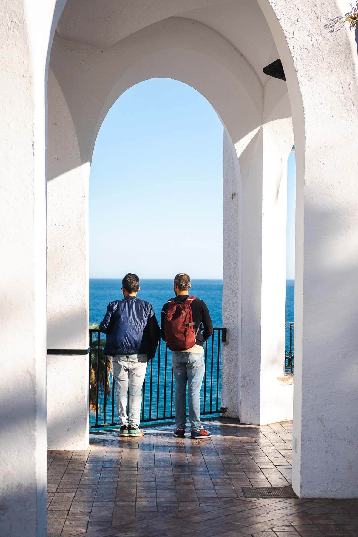 two guys watching the sea view from Europe's Balcony in Nerja.