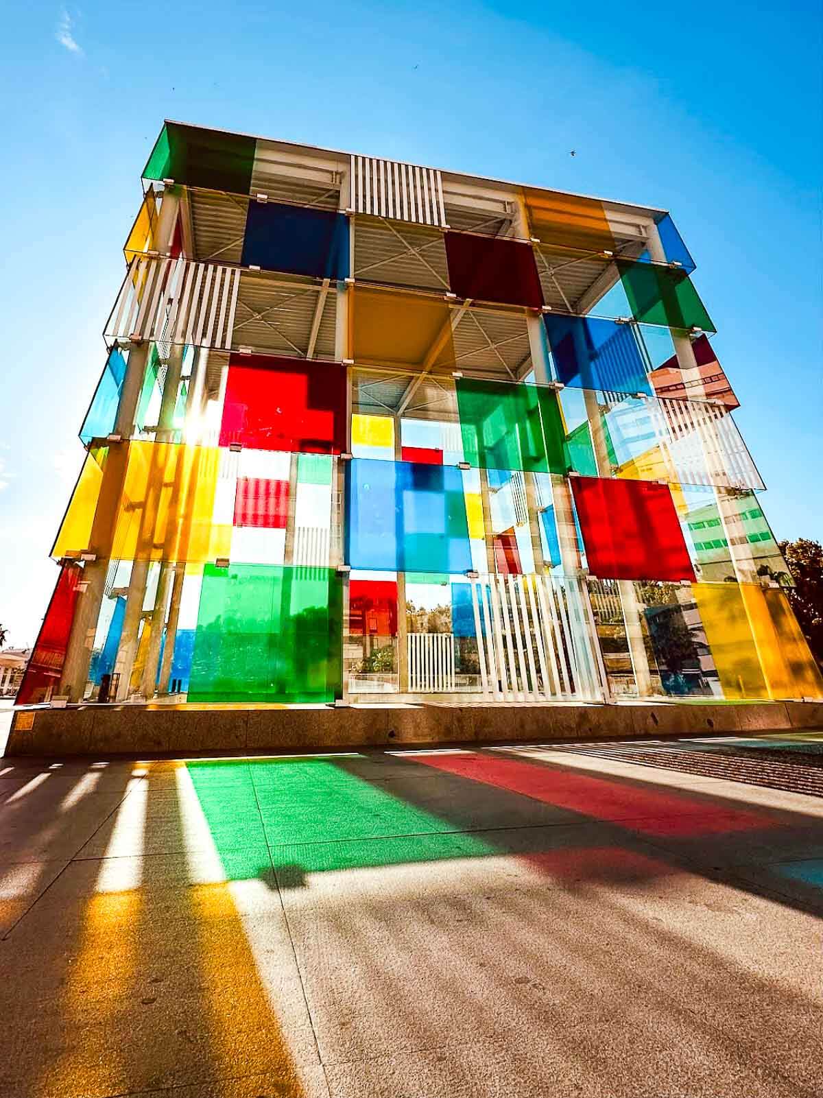 View of the Pompidu Museum in Malaga featuring its iconic colorful square glasses.