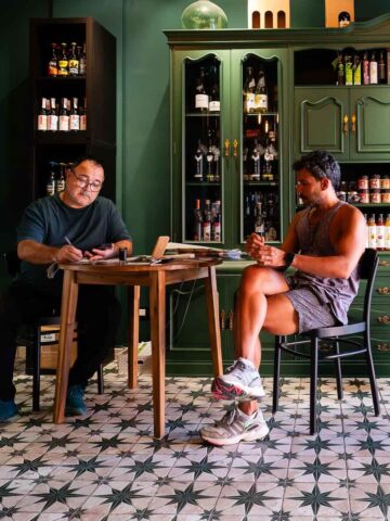 Jacinto hosting a wine tasting session - Jacinto sharing knowledge with a guest seated in the vinoteca.