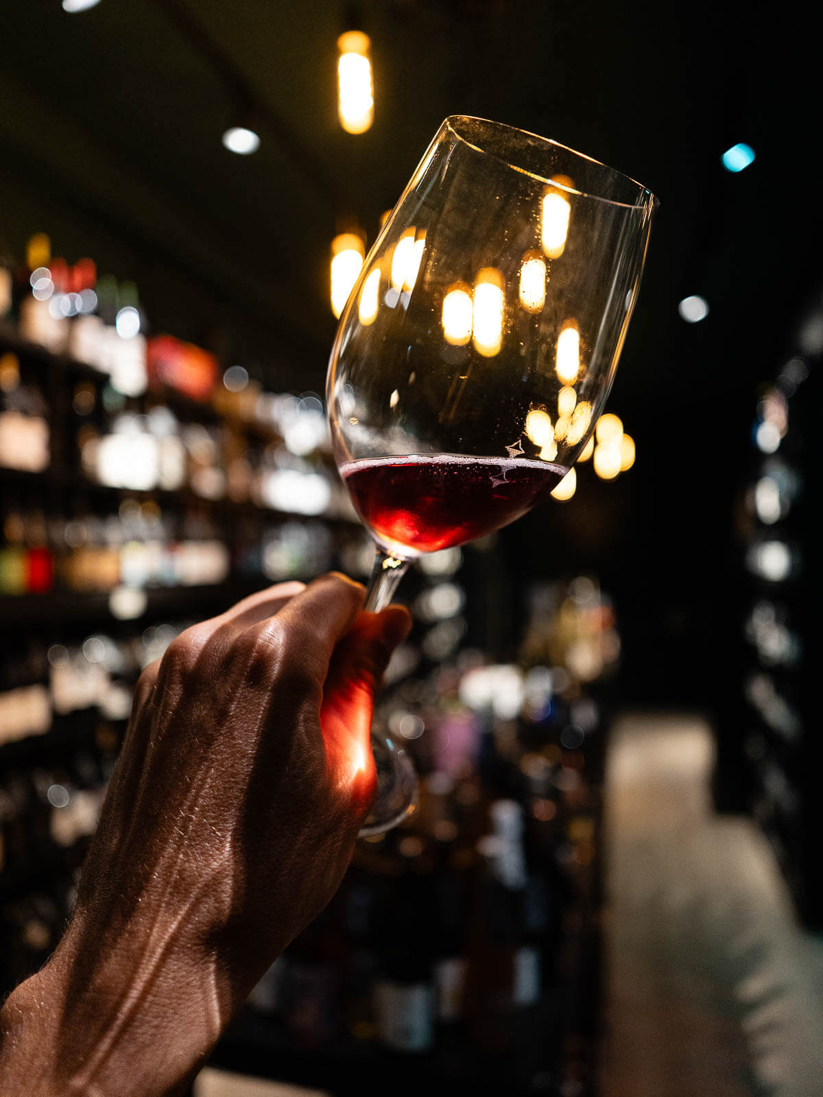 Artistic wine swirl close-up in a glass - A glass of Canarian wine held against a warm ambiance.