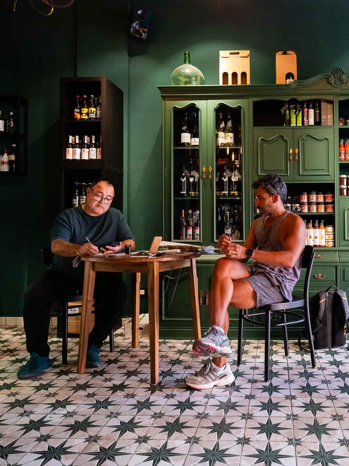 Jacinto hosting a wine tasting session - Jacinto sharing knowledge with a guest seated in the vinoteca.