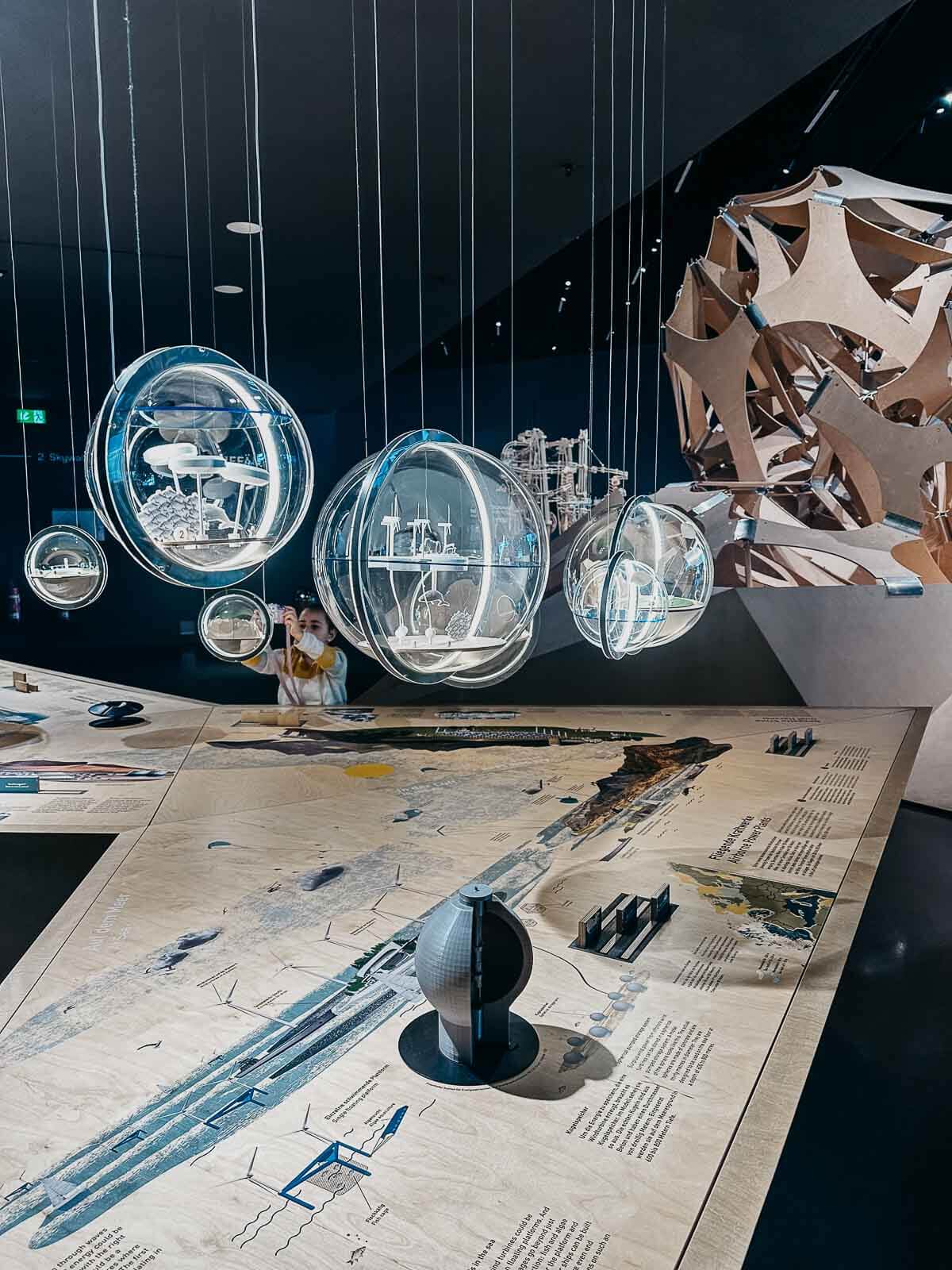 Glass-made spheres portraying futuristic realities in the Futurium museum.