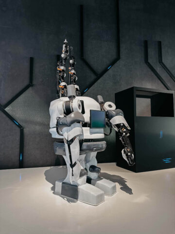 A life-sized robot displayed in a futuristic exhibit at the Futurium in Berlin, showcasing cutting-edge technology.