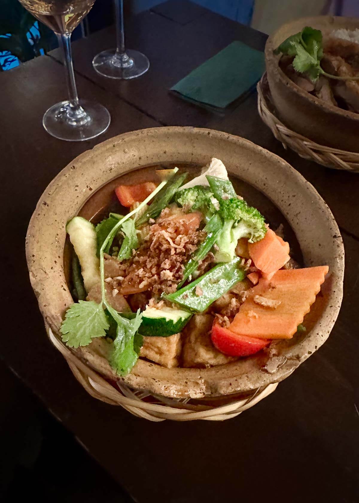 A vibrant plant-based seitan dish with fresh greens, and nuts served at a Berlin vegan restaurant.