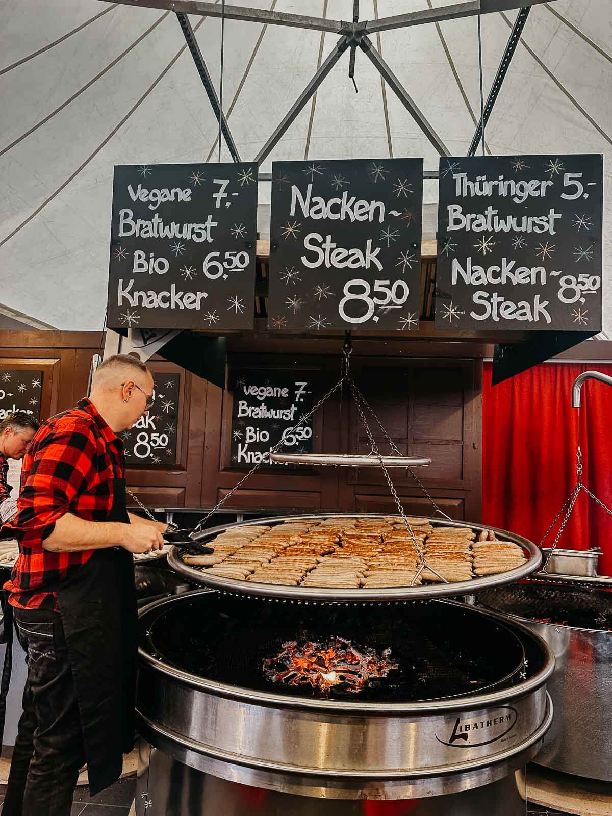 A food stall at a Berlin market offering vegan bratwurst and other plant-based delicacies.