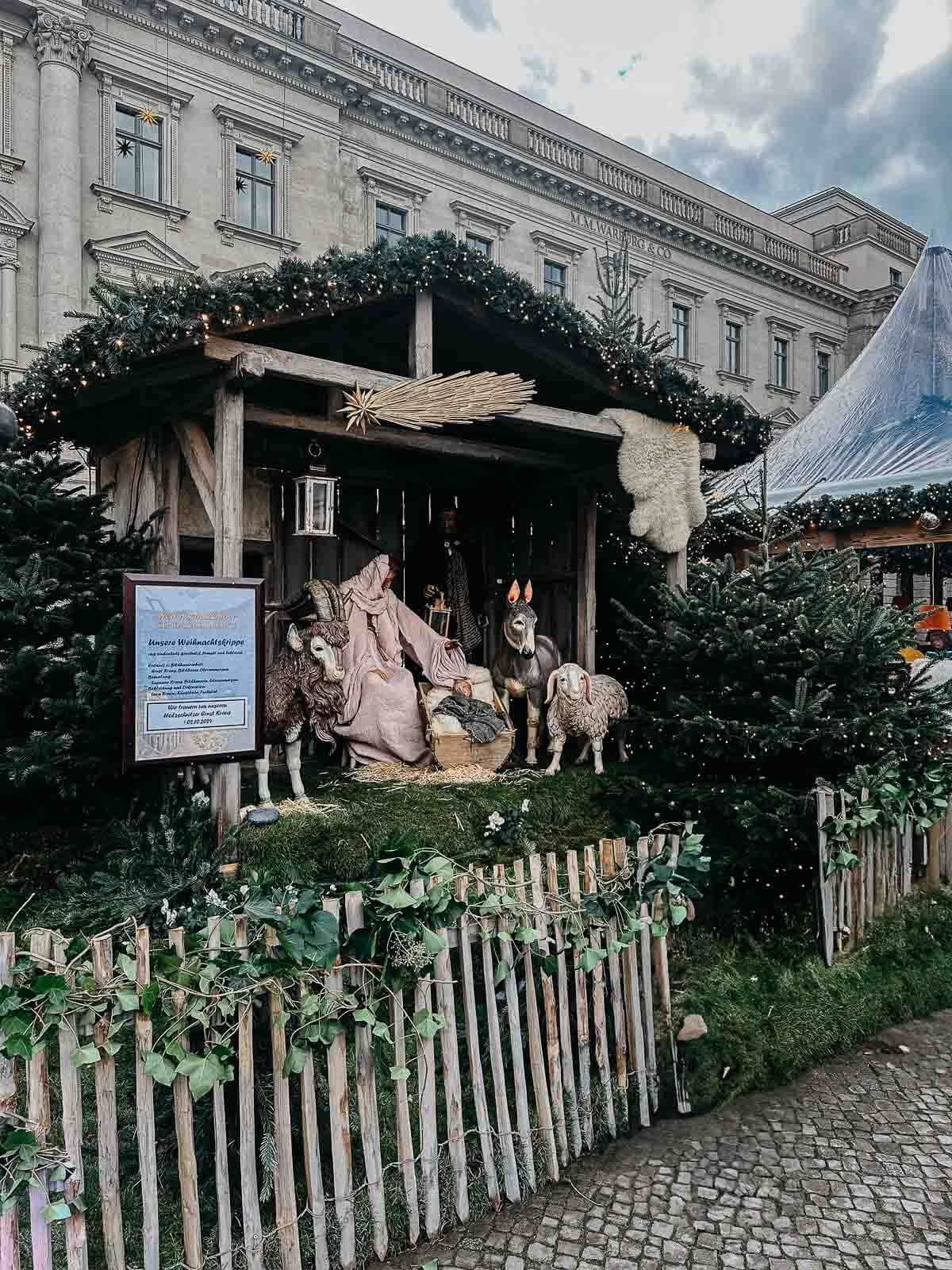 A charming nativity scene at a Berlin Christmas market, complete with handcrafted figures and decorations.