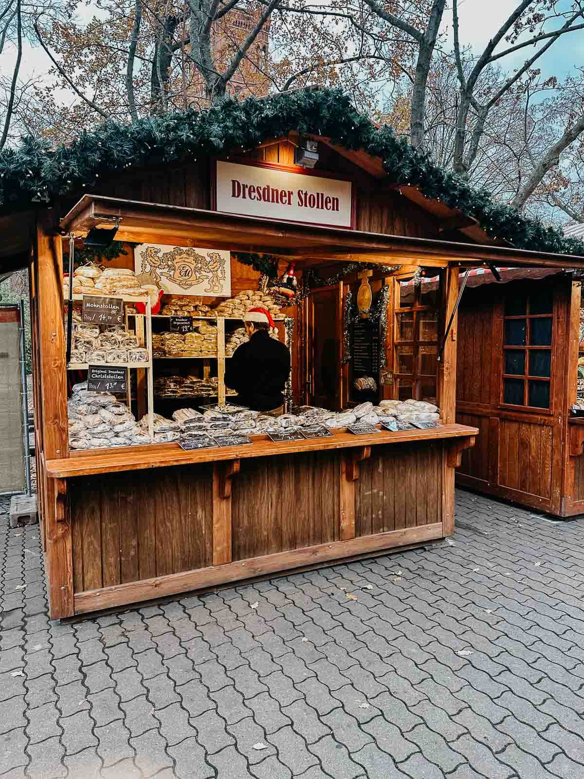 A winter market stall in Berlin showcasing freshly baked bread and pastries, with a rustic wooden design.