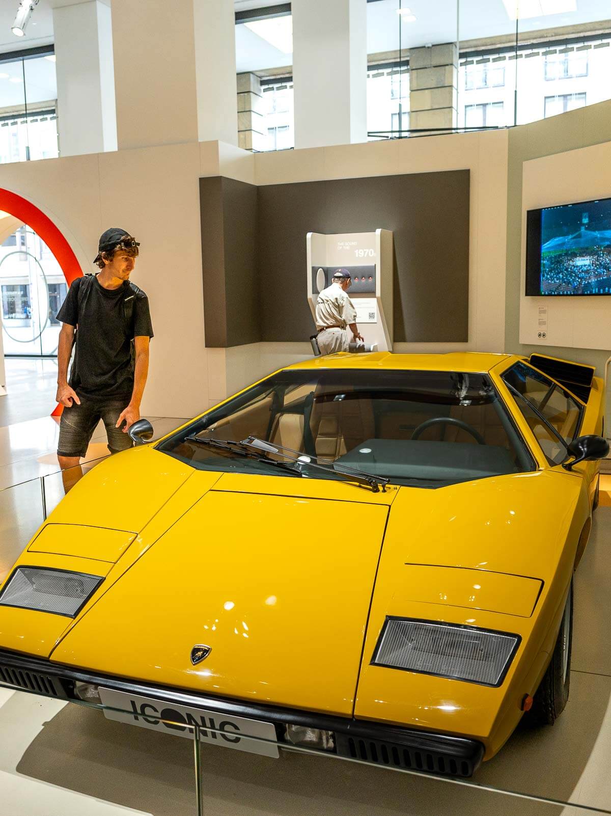 Man watching a yellow card in the Volkswagen Museum in Berlin.