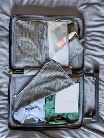 Detailed view of LEVEL8 suitcase compartments with personal travel items neatly packed.