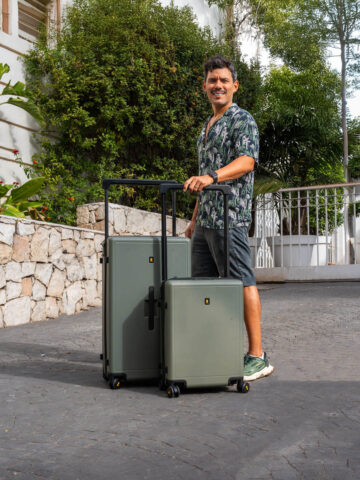 LEVEL8 Voyageur luggage 2-piece set standing upright on pavement during Mediterranean trip.