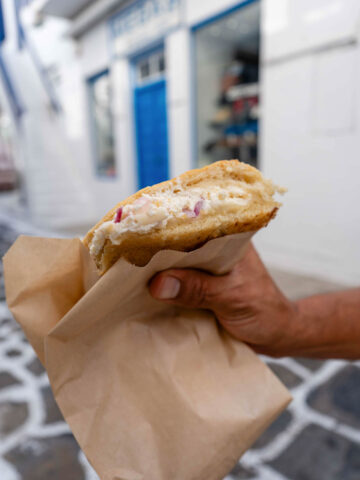hand holding an onion pie.