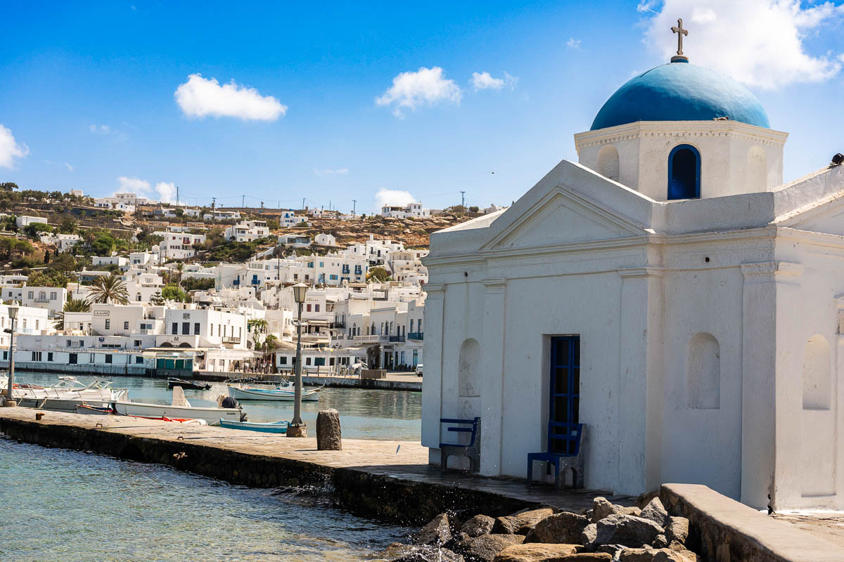 Iconic Cycladic church with a blue dome overlooking the Aegean in Mykonos.