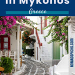 Colorful Greek alleyway with whitewashed buildings, vibrant bougainvillea, and traditional cobblestone streets in Mykonos, Greece. A picturesque scene ideal for travel and adventure lovers.