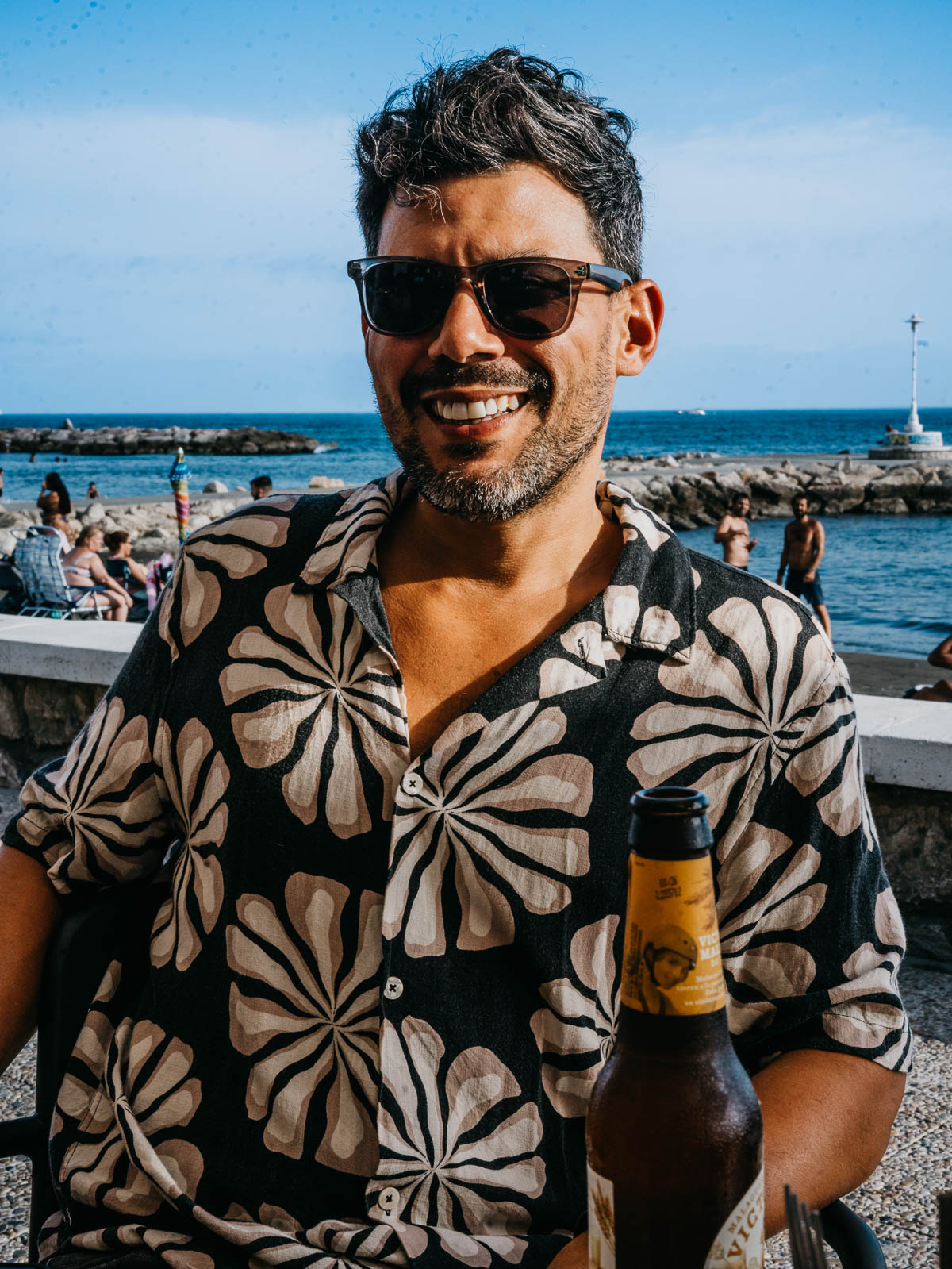 man having a bear at Pedregalejo's restaurant next to the beach.