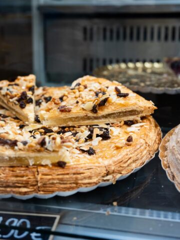 Traditional Pastel Cordobés with almonds and raisins on display.